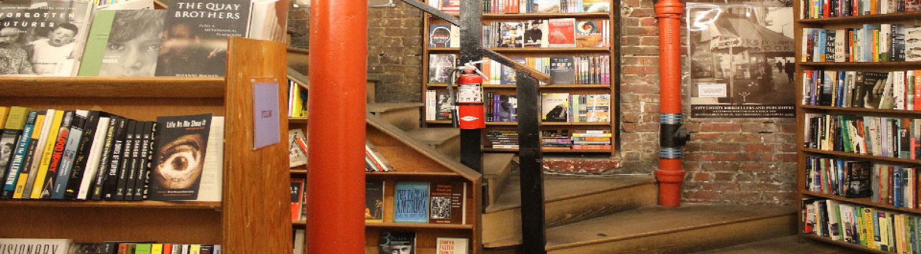 Inside the book shoppe with a brick interior wall